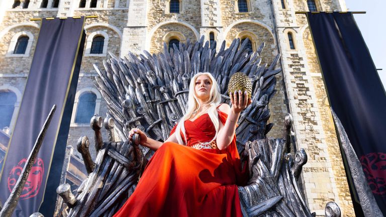 Cosplayer and super fan Sophia sits on the Iron Throne outside the Tower of London to mark the launch of the Game of Thrones prequel