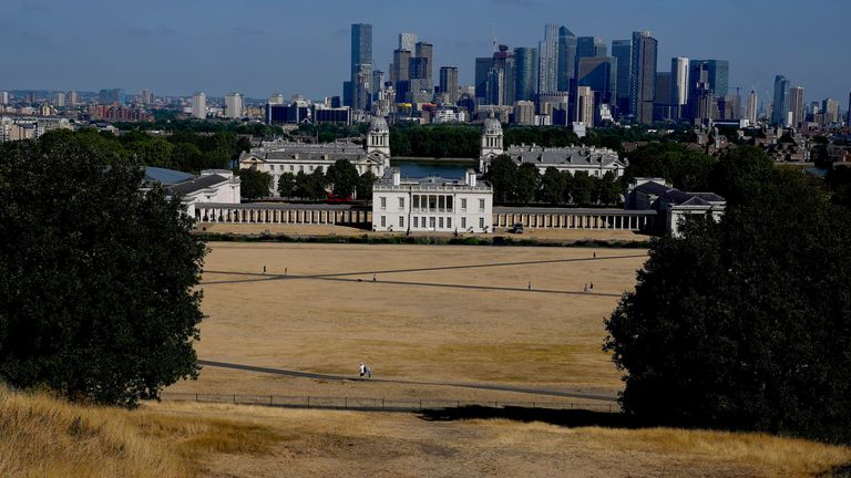 Dry and sun burnt grass spreads in Greenwich Park with the backdrop of Queens House and the high risers of Canary Wharf in London, Tuesday, Aug. 9, 2022. Britain is braced for another heatwave that will last longer than July&#39;s record-breaking hot spell, with highs of up to 35 C expected next week. (AP Photo/Frank Augstein)
PIC:AP