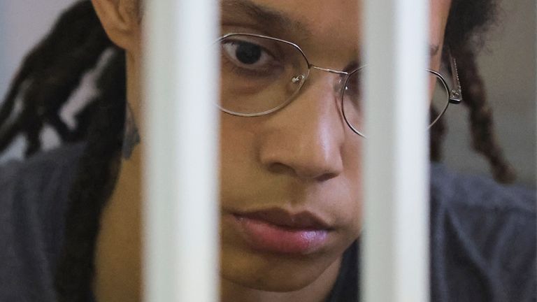 WNBA star and two-time Olympic gold medalist Brittney Griner awaits sentencing as she stands in a cage in a courtroom in Khimki, near Moscow, Russia, Thursday, Aug. 4, 2022. US basketball star Brittney Griner apologized to her family and teams.  A Russian court hearing closing arguments in the drug possession trial said it expected a verdict later Thursday.  (Evgenia Navazhenina/Pool Photo via AP)