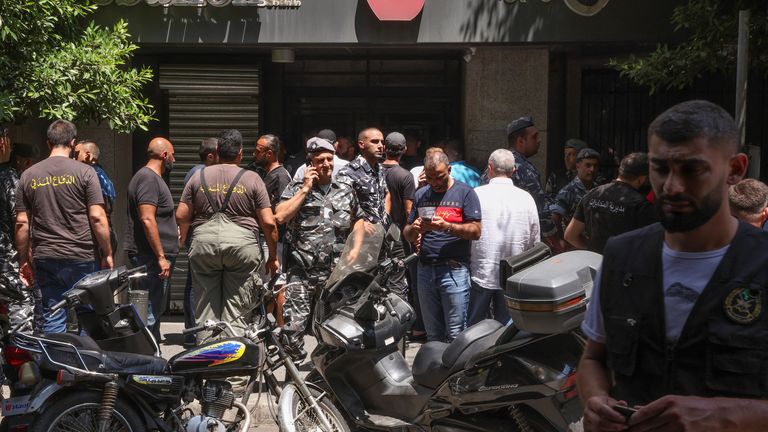 Members of Lebanese police and civil defence secure the area outside Federal bank in Hamra, Lebanon August 11, 2022. REUTERS/Mohamed Azakir
