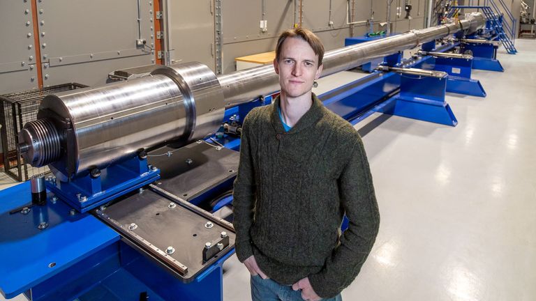 Dr Nick Hawker, chief executive of First Light Fusion, stands in front of the UK's largest supersonic airgun.  Image: 