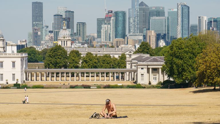 A man sunbathes in a nearly empty Greenwich Park, London, as a drought has been declared for parts of England following the driest summer for 50 years