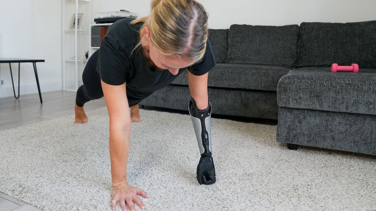     Jessica Smith, a former Paralympic swimmer from Australia during a workout while using her new bionic hand
