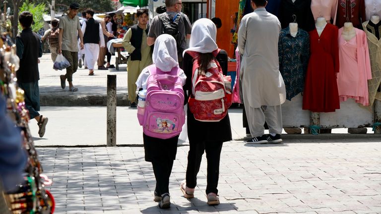Afghan girls walk in Kabul