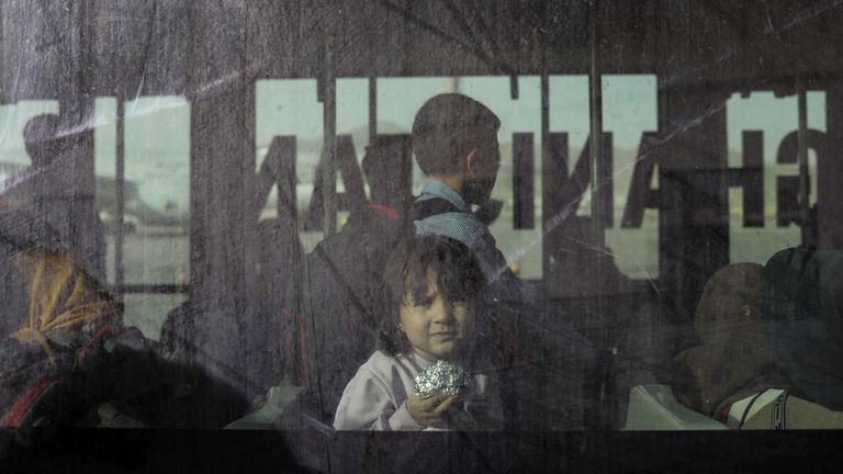 An Afghan child looks through a window while riding a shuttle bus to a flight at the international airport in Kabul, Afghanistan, September 10, 2021. WANA (West Asia News Agency) via REUTERS ATTENTION EDITORS - THIS IMAGE HAS BEEN SUPPLIED BY A THIRD PARTY.