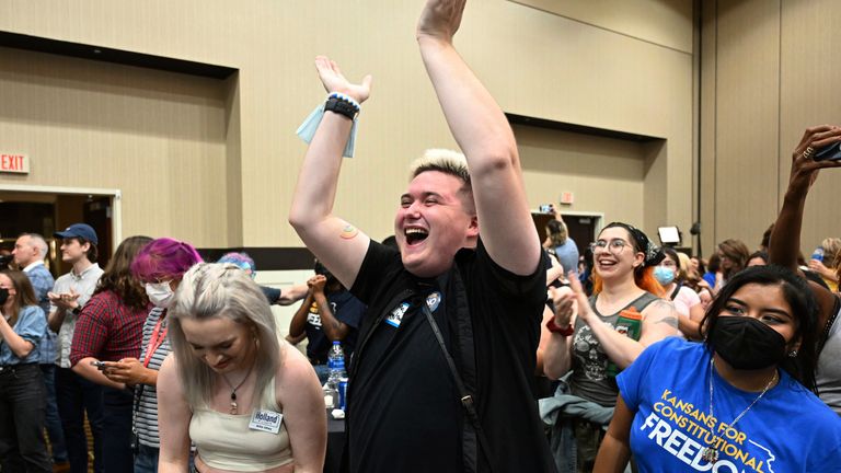 Allie Utley, left, and Jae Moyer, center, of Overland Park react during a primary watch party Tuesday, Aug. 2, 2022, at the Overland Park (Kan.) Convention Center.  Kansas voters on Tuesday protected the right to abortion in their state, rejecting a measure that would have allowed their Republican-controlled legislature to tighten restrictions on abortion or ban it outright.  (Tammy Ljungblad/The Kansas City Star via AP)