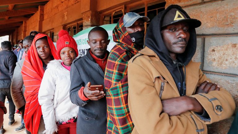 Voters queue before casting their ballots during the general election by the Independent Electoral and Boundaries Commission (IEBC) in Mashimoni village of Kibera slums of Nairobi, Kenya August 9, 2022. REUTERS/Thomas Mukoya
