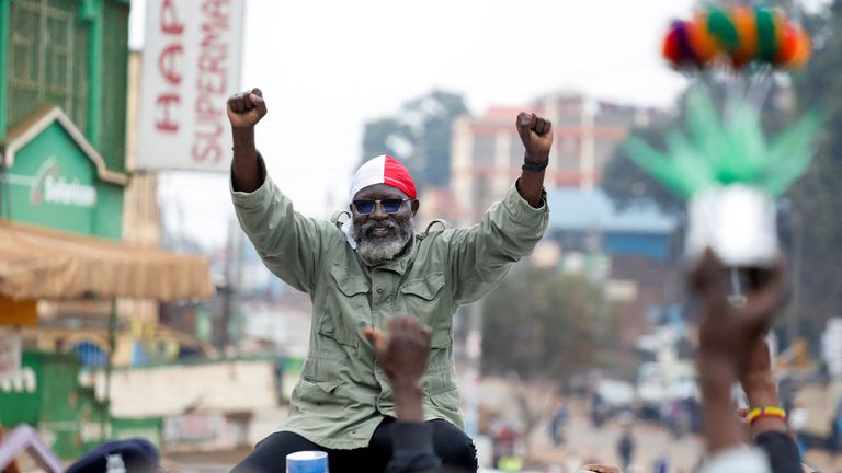 A supporter of Kenyan presidential candidate George Wajackoyah holds his poster during an election campaign rally In Gatundu, Kenya, August 3, 2022. REUTERS/Baz Ratner

