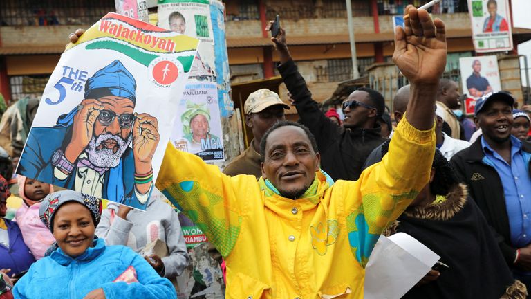 A supporter of Kenyan presidential candidate George Wajackoyah holds his poster during an election campaign rally In Gatundu, Kenya, August 3, 2022. REUTERS/Baz Ratner
