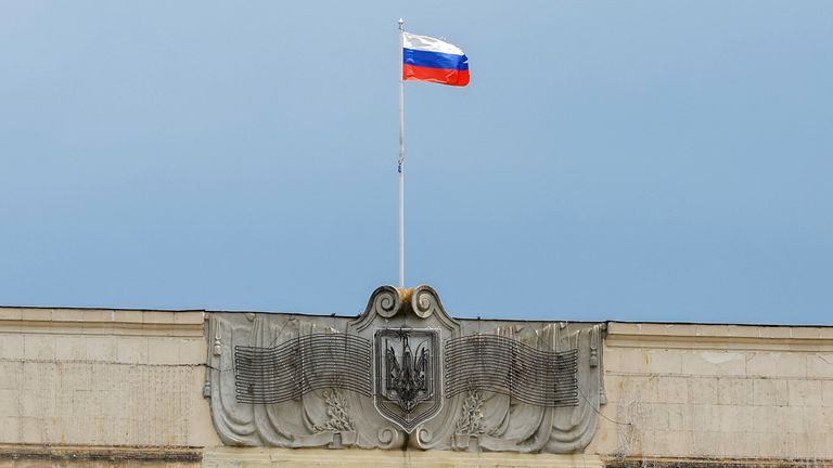 A Russian flag flies above a government building in occupied Kherson