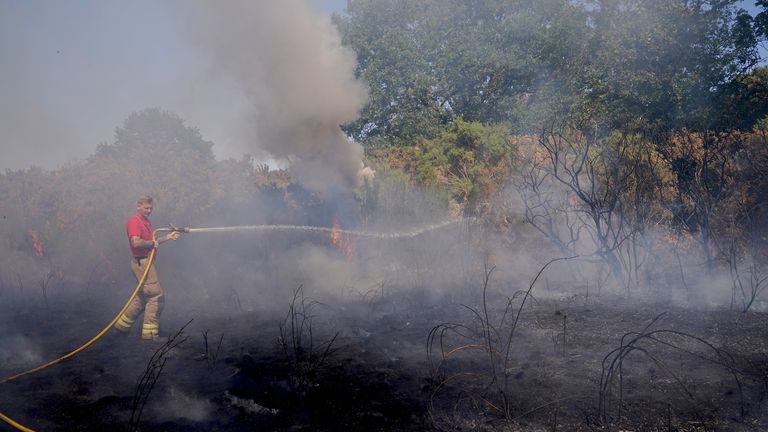 Firefighters battle a grass fire on Leyton flats in east London, as a drought has been declared for parts of England following the driest summer for 50 years. Picture date: Friday August 12, 2022.

