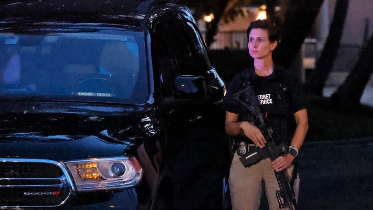 An armed Secret Service agent stands outside an entrance to former President Donald Trump&#39;s Mar-a-Lago estate, Monday, Aug. 8, 2022, in Palm Beach, Fla. Trump said in a lengthy statement that the FBI was conducting a search of his Mar-a-Lago estate and asserted that agents had broken open a safe. (AP Photo/Terry Renna)