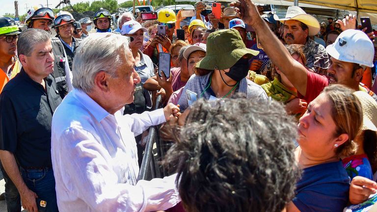 Mexico&#39;s President Andres Manuel Lopez Obrador speaks with people as he visits a coal mine that collapsed leaving miners trapped in Sabinas, Coahuila state