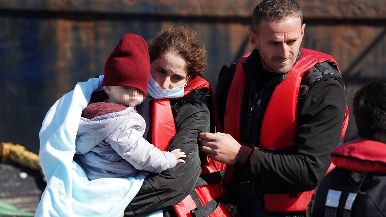  A young child is carried amongst a group of people thought to be migrants as they are brought in to Dover, Kent, from a Border Force Vessel, following a small boat incident in the Channel. Picture date: Tuesday August 23, 2022.