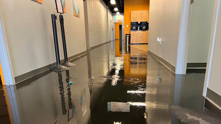 In this photo provided by Pastor Bryant May, approximately three inches of water flows into Exchange Church in Pearl, Miss., Wednesday, August 24, 2022, as flash floods hit the surrounding area.  (Pastor Bryant May via AP)