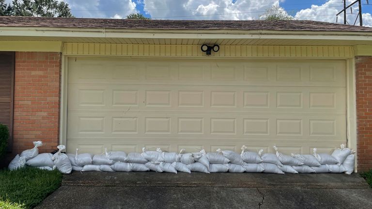 Residents lined their doors and garages with sandbags to block the water in the North Canton Circle neighborhood of Jackson, Miss., on Monday, Aug. 29, 2022. Officials said they deployed 126,000 sandbags act as water barriers. (AP Photo/Michael Goldberg)