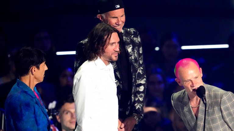 Flea, of Red Hot Chili Peppers, accepts the award for best rock for "Black Summer" at the MTV Video Music Awards at the Prudential Center on Sunday, Aug. 28, 2022, in Newark, N.J. From left looking on are fellow band members Anthony Kiedis, John Frusciante and Chad Smith. (Photo by Charles Sykes/Invision/AP)