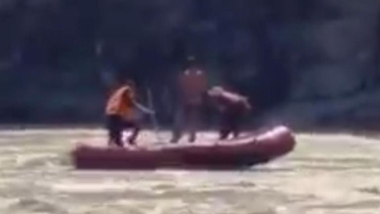 A rescue team braved treacherous waters in a dinghy to save a 13-year-old boy trapped in the middle of a river in Pakistan, footage posted on August 30 shows.
