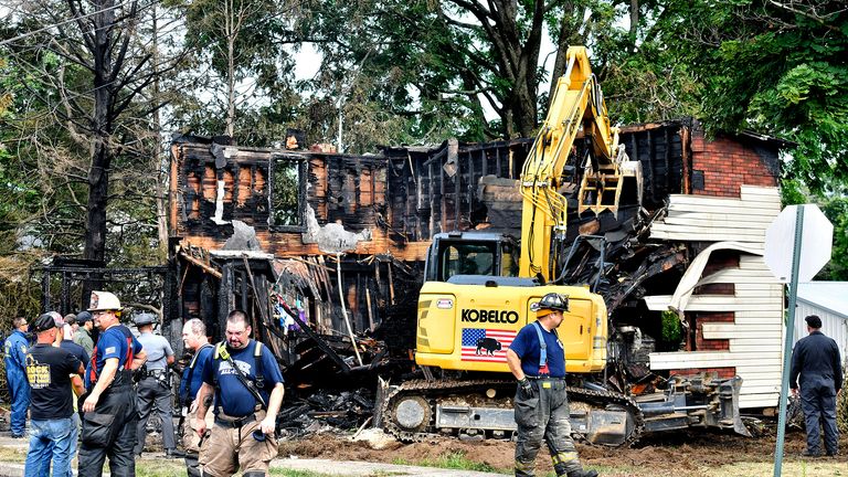 Crews work to demolish a house that was destroyed by a fatal fire on the 700 block of 1st St. in Nescopeck, Pa., Friday, Aug. 5, 2022. Multiple people are feared dead after a house fire early Friday in northeastern Pennsylvania, according to a volunteer firefighter who responded and said the victims were his relatives. A criminal investigation is underway, police said. (Sean McKeag/The Citizens&#39; Voice via AP)