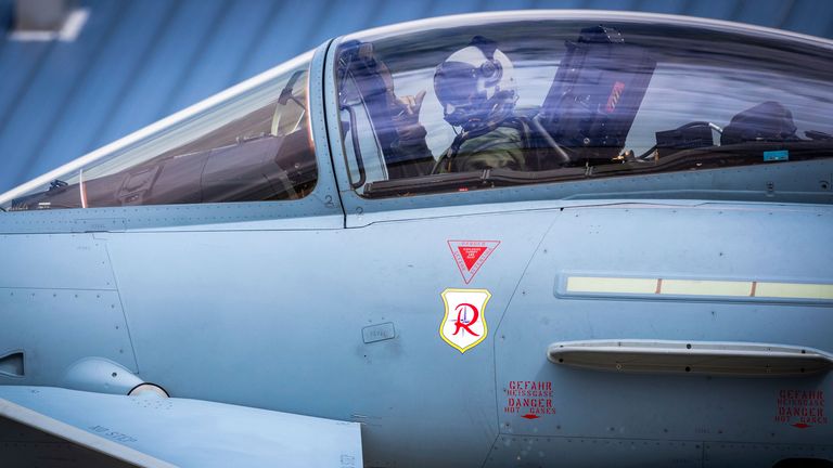 A pilot in Germany salutes from the cockpit of a Eurofighter as it heads towards Estonia. Pic: AP