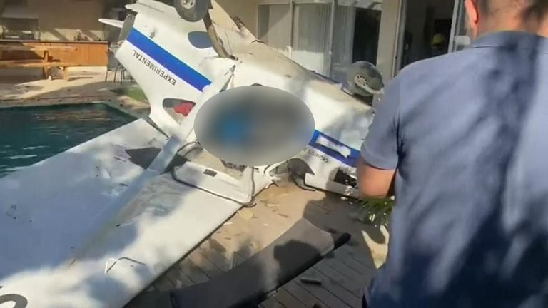 Small plane crashes in Brazil next to a swimming pool after skimming house roof