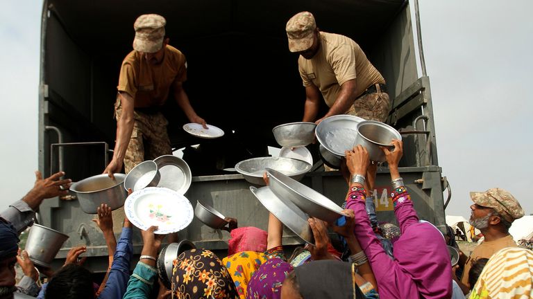 Army troops distribute food and other stuff to displace people in a flood-hit area in Rajanpur, district of Punjab, Pakistan, Saturday, Aug. 27, 2022. Officials say flash floods triggered by heavy monsoon rains across much of Pakistan have killed nearly 1,000 people and displaced thousands more since mid-June. (AP Photo/Asim Tanveer)
PIC:AP
