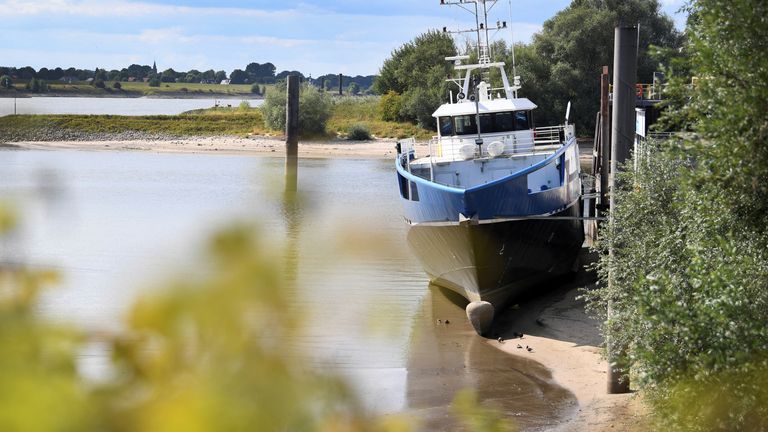 A view of a ship that has run dry at the harbour due to the low water level in the Rhine River in Lobith, Netherlands August 8, 2022. REUTERS/Piroschka van de Wouw
