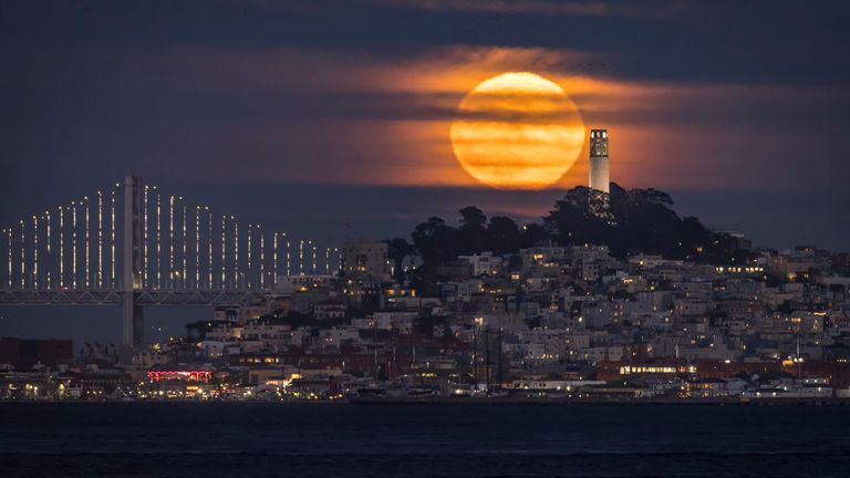 A supermoon, also known as the sturgeon moon, rises with San Francisco&#39;s Coit Tower in the foreground, seen from from Sausalito, Calif., Thursday, Aug. 11, 2022. (Carlos Avila Gonzalez/San Francisco Chronicle via AP)