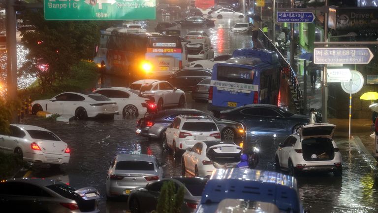 Abandoned vehicles fill the road in flooded area during heavy rain in Seoul, South Korea, August 8, 2022. Yonhap via REUTERS ATTENTION EDITORS - THIS IMAGE HAS BEEN SUPPLIED BY A THIRD PARTY. SOUTH KOREA OUT. NO RESALES. NO ARCHIVE. NUMBER PLATES BLURRED AT SOURCE
