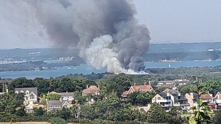 Photo taken courtesy of @JD_GardenM's Twitter feed of thick black smoke billowing from the stage at Studland Heath, Dorset, as a drought has been declared for parts of England following the summer on driest for 50 years.  Picture date: Friday August 12, 2022.