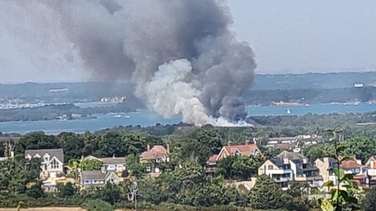 Handout photo taken with permission from the Twitter feed of @JD_GardenM of heavy black smoke rising from the scene on Studland Heath, Dorset, as a drought has been declared for parts of England following the driest summer for 50 years. Picture date: Friday August 12, 2022.
