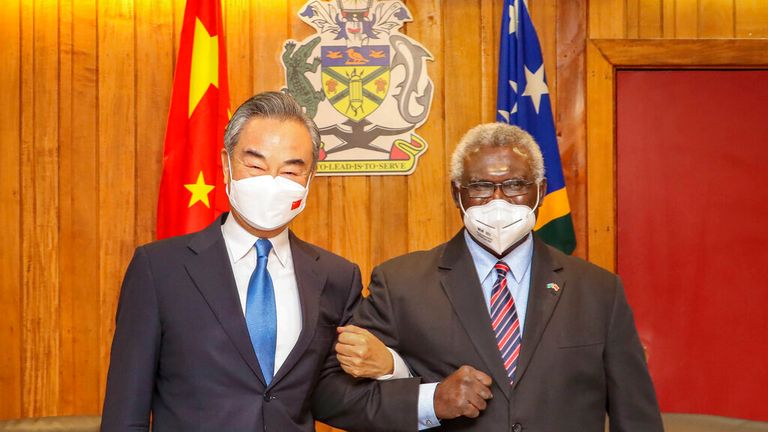 Solomon Islands Prime Minister Manasseh Sogavare, right, locks arms with visiting Chinese Foreign Minister Wang Yi in May 2022t. Pic: AP