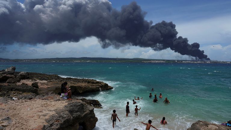 A cloud of black smoke can be seen for miles