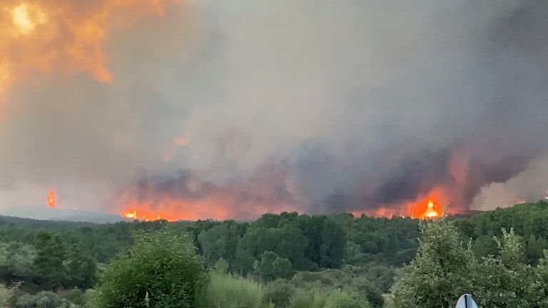 Smoke and flames from a wildfire in Caceres, Spain