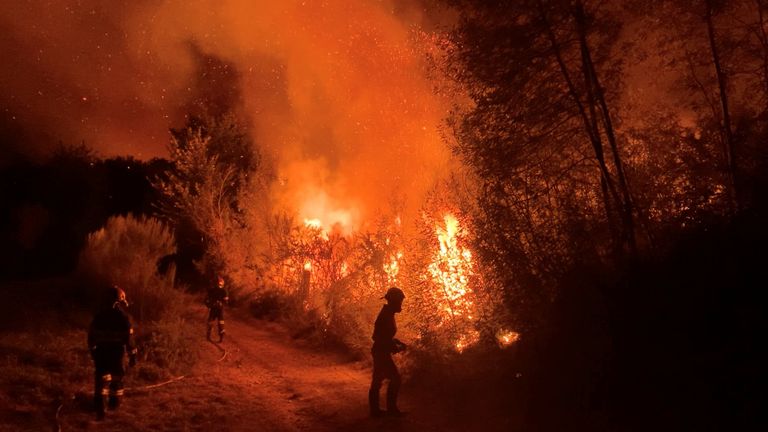 Firefighters work to extinguish a wildfire in Verin, Spain August 3, 2022 in this screen grab obtained from a video. Felipe Carnotto/via REUTERS THIS IMAGE HAS BEEN SUPPLIED BY A THIRD PARTY. MANDATORY CREDIT.
