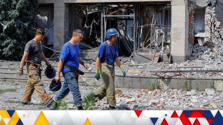 Rescuers walk past a hotel building recently hit by shelling in the course of Ukraine-Russia conflict in the Russian-controlled town of Svitlodarsk in the Donetsk region, Ukraine August 8, 2022. REUTERS/Alexander Ermochenko