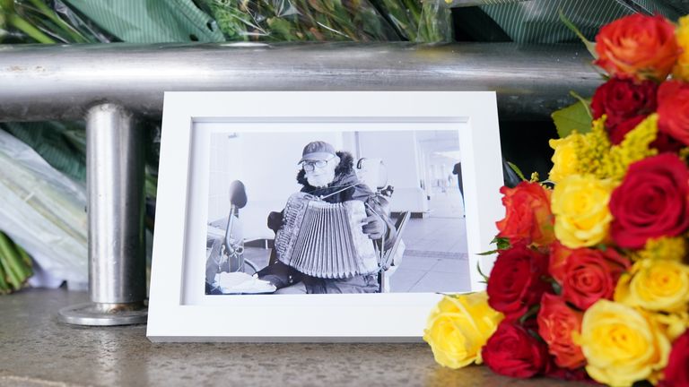 A picture of Thomas O&#39;Halloran left amongst floral tributes outside Perivale Tesco, Greenford, where the 87-year-old, who was fatally stabbed in Greenford, west London on Tuesday, used to play his accordion. Picture date: Friday August 19, 2022.

