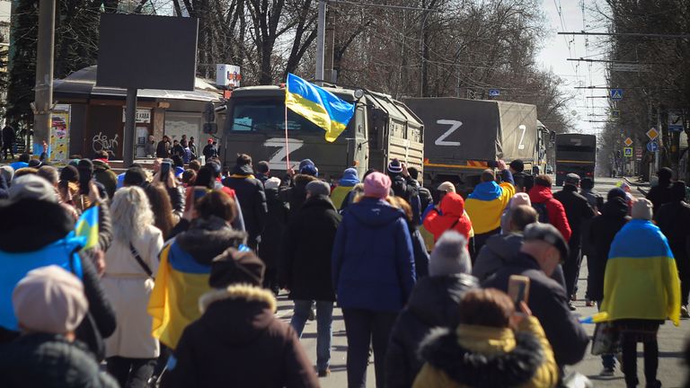 People with Ukrainian flags walk towards Russian army trucks during a rally against the Russian occupation in Kherson, Ukraine, Sunday, March 20, 2022. Ever since Russian forces took the southern Ukrainian city of Kherson in early March, residents sensed the occupiers had a special plan for their town. Now, amid a crescendo of warnings from Ukraine that Russia plans to stage a sham referendum to transform the territory into a pro-Moscow "people&#39;s republic," it appears locals guessed right. (AP P