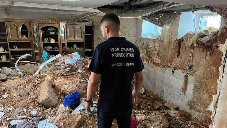 A war crimes prosecutor examines damage in Mykolaiv in July. Pic: Mykolaiv Regional Prosecutor&#39;s Office/Reuters.
