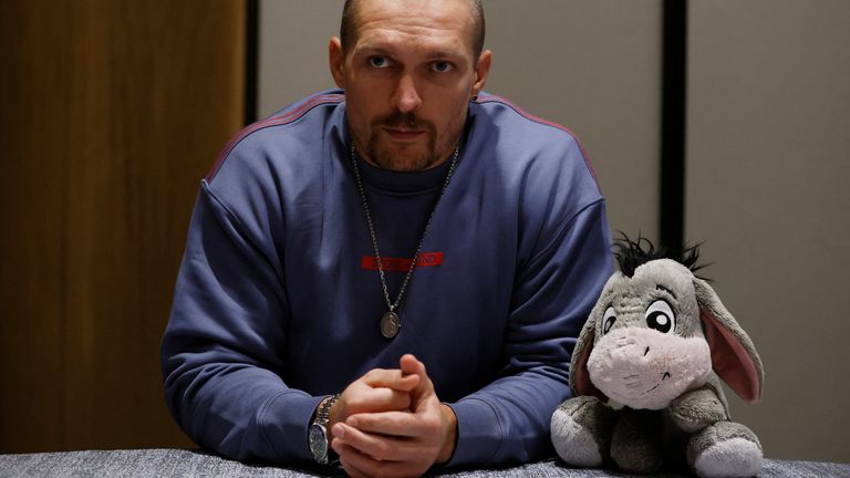 Usyk with an Eeyore stuffed toy, during a news conference in August