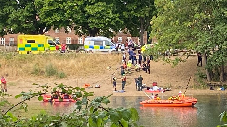 Police search for a person in the water at Hampton Court