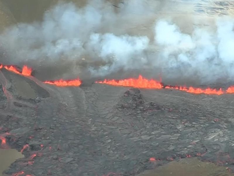 The Fagradalsfjall volcano in Iceland erupts with molten lava and smoke spewing from a fissure in the ground