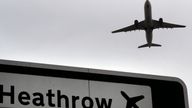 A plane takes off over a road sign near Heathrow Airport in London, Tuesday, June 5, 2018. The British Cabinet has approved the construction of a third runway at Heathrow Airport, and to put the long-running issue up for a parliamentary vote. (AP Photo/Kirsty Wigglesworth)