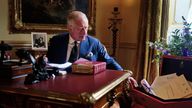 King Charles III carrying out official government duties from his red box in the Eighteenth Century Room at Buckingham Palace