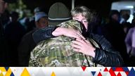 A woman bids farewell to a reservist in the Siberian settlement of Bolsherechye