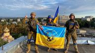 Ukrainian soldiers hold a flag at a rooftop in Kupiansk, Ukraine in this picture obtained from social media released on September 10, 2022. Telegram @kuptg/via REUTERS THIS IMAGE HAS BEEN SUPPLIED BY A THIRD PARTY. MANDATORY CREDIT. NO RESALES. NO ARCHIVES.