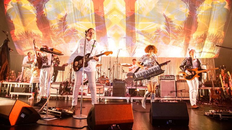 Win Butler, from left, Regine Chassagne and Tim Kingsbury of Arcade Fire perform at the Krewe du Kanaval Mardi Gras Ball at Mahalia Jackson Theater for the Performing Arts on Friday, Feb. 14, 2020, in New Orleans. (Photo by Amy Harris/Invision/AP)