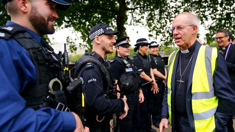The Archbishop of Canterbury Justin Welby talks to police officers near the final section of the queue to see the coffin of Queen Elizabeth II outside the Palace of Westminster in central London. Picture date: Thursday September 15, 2022.
