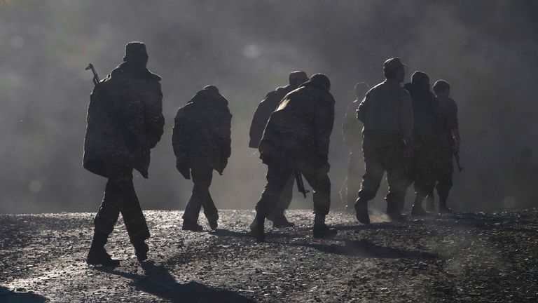 Ethnic Armenian soldiers walk along the road near the border between Nagorno-Karabakh and Armenia, Nov. 8, 2020