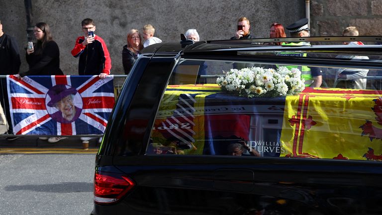 The hearse carrying the coffin of Britain&#39;s Queen Elizabeth passes through the village of Ballater, near Balmoral, Scotland, Britain, September 11, 2022. REUTERS/Kai Pfaffenbach
